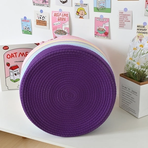 Detail of colorful Nordic woven cotton rope storage basket with rainbow striped pattern