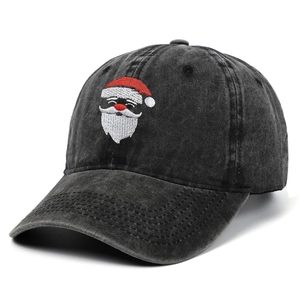Washed black cotton baseball cap featuring festive Santa Claus embroidery at a 45-degree angle