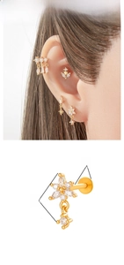 Detailed view of flower-shaped copper labret stud with titanium post and white zircon stones
