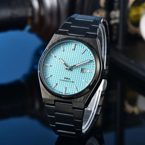 Macro shot of light blue waffle dial on PRX watch with silver hands and calendar window
