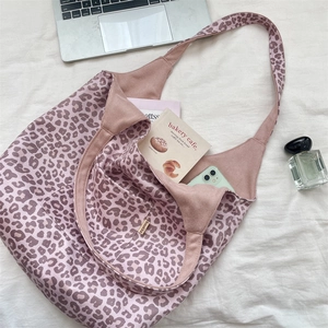 Detailed interior view of a pink leopard print tote bag with inner pocket and soft suede texture