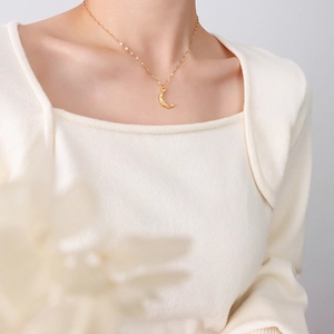 18K gold plated stainless steel crescent moon pendant necklace worn by a female model