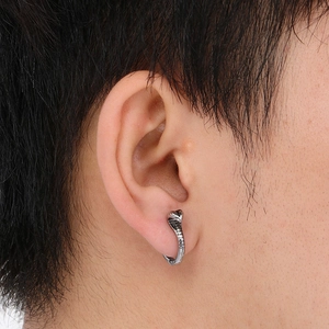 Macro view of vintage cobra snake earring in polished dark grey stainless steel on ear