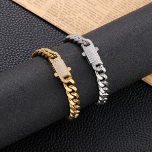 Hip hop Cuban link bracelets in gold and silver with iced out diamond buckles on black stand