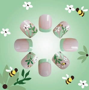 French tip press-on nails with pink base, mint green edges, and floral bee patterns
