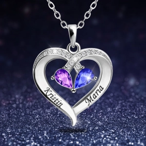 Macro shot of silver heart necklace with blue and purple stones and custom engravings