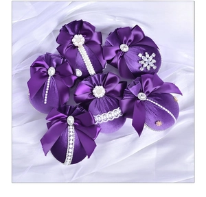 Close-up of 6 purple velvet Christmas balls with pearls, lace and rhinestone details