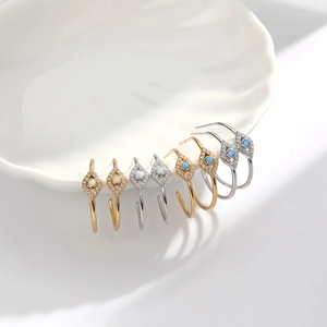 Detailed macro view of S925 sterling silver blue opal evil eye stud earrings with crystals
