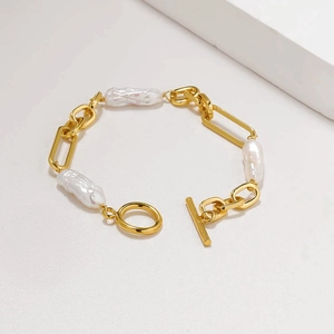 Detail of baroque pearl bracelet with gold chain and toggle clasp closure