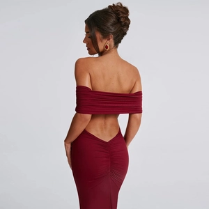 Macro shot of back ruching and backless design on deep red off-shoulder evening dress
