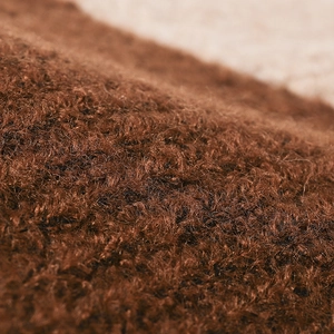 Close-up of caramel brown thick mohair wool knit texture for winter outdoor beanies