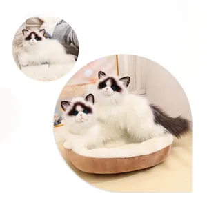 Detailed realistic ragdoll cat plush set with a brown pet bed on wooden floor