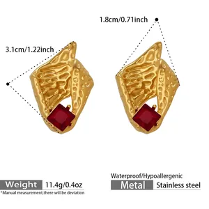 Detailed close-up of conch-shaped gold stainless steel earrings with square red zircon stone