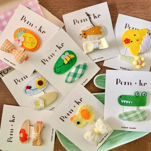 Cute cartoon animal fabric hair clips and bow set for girls on pink plaid background