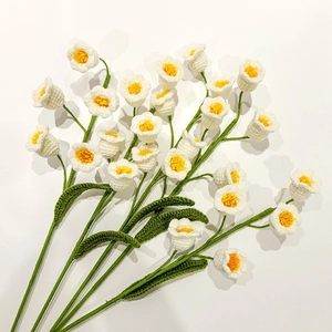 Handmade knitted lily of the valley bouquet with white flowers and green leaves