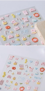 Macro detail of 3D embossed nail stickers featuring cute pink pigs and cartoon patterns