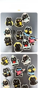 Collection of various cartoon black cat acrylic brooches on a metallic surface