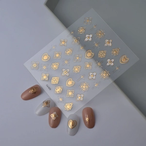 Macro shot of 3D embossed gold star and floral nail art stickers on matte manicured nails
