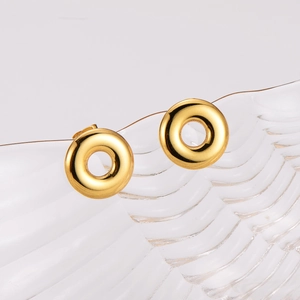 Minimalist gold hoop earrings displayed on ripple glass with high metal shine finish