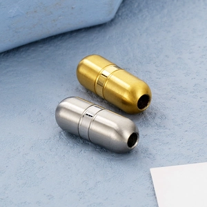 Macro shot of gold and silver capsule-shaped metal connectors for DIY jewelry making
