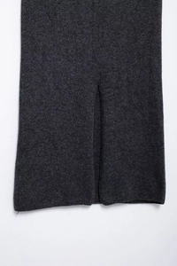 Detail of dark grey knitted fabric with clear texture and stylish slit cuff design
