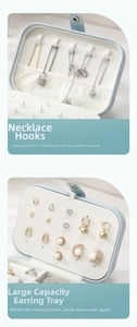 Detail view of blue travel jewelry box with 5 necklace hooks and large earring stud plate