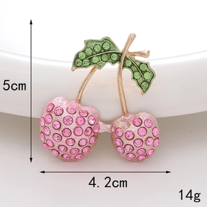 Detail showing 5cm x 4.2cm dimensions of a pink cherry brooch with inlaid rhinestones