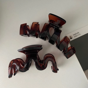 Brown tortoiseshell hair claw clips with geometric and wavy designs for women