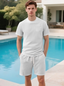 Detail of white waffle knit texture on men's t-shirt and shorts set with drawstring