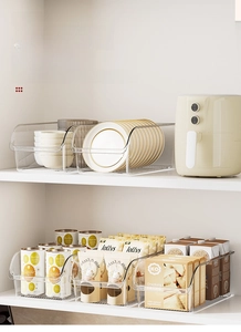 Close-up of clear PET storage boxes with handles showing kitchen organization detail