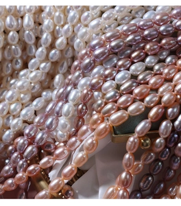Macro shot of 5-6mm natural freshwater rice pearls in white, pink and purple shades