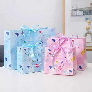 Starry sky gift bags with silk bows and planet patterns in pink and blue colors