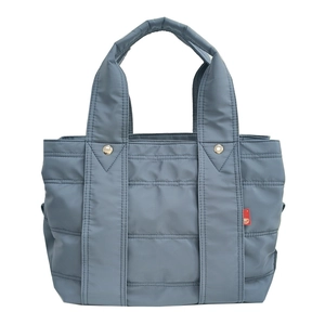 Detail of blue-grey quilted nylon tote bag with high-quality stitching and metal snap button
