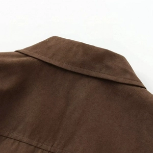 Cropped view of brown suede jacket showing collar details and stitching quality