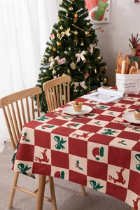 Detailed view of red and beige checkered Christmas tablecloth with reindeer pattern