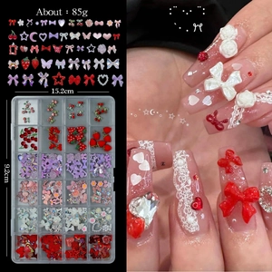 Detailed 24-grid nail art kit with resin bows and pearls in a 15.2cm compact storage box