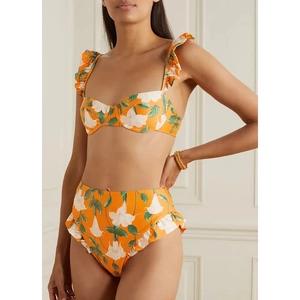 Detail of high-waist floral bikini bottoms with orange ruffles and white flower patterns