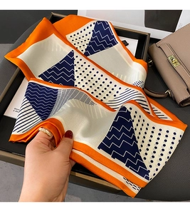 Detail showing high-quality faux silk scarf texture with geometric dot and stripe patterns