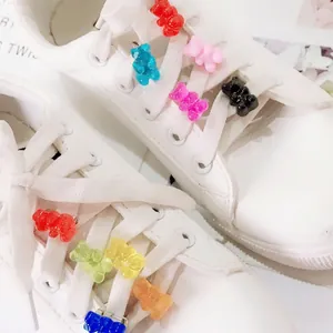Colorful resin gummy bear charms set on white sneakers with various vibrant candy colors