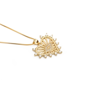 Detailed view of a gold heart pendant with evil eye motif and zircon border