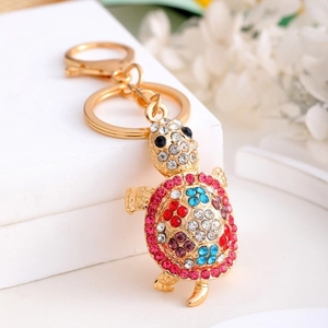 Detailed close-up of golden turtle keychain with vibrant colorful rhinestones