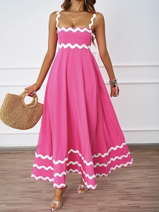 Detail of pink summer maxi dress with white wavy trim and adjustable straps for vacation