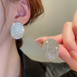 Elegant gold round stud earrings with full pavé crystals in luxury geometric design