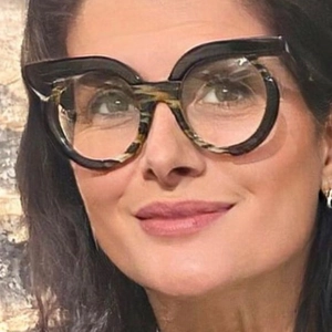 Close-up of stylish round leopard print glasses frames worn by a woman outdoors