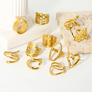 Set of 18K gold plated stainless steel rings featuring snake, heart and geometric designs