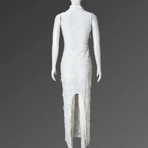 Detail of the white sleeveless maxi dress featuring unique distressed fringe texture on back