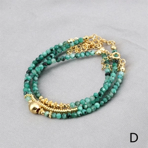 Detailed view of triple-layered green stone bead bracelet with adjustable gold-plated clasp