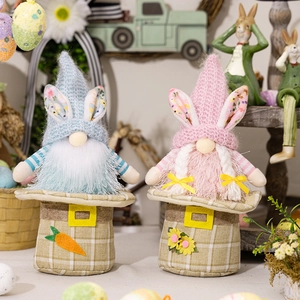 Detail view of plush Easter gnomes with rabbit ears, plaid bags, and carrot decorations