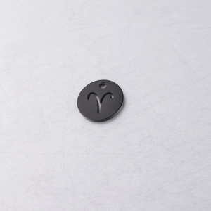 Macro detail of a 12mm black Aries zodiac sign charm with cutout design for DIY jewelry