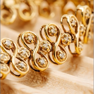 Luxury vintage gold women's watch featuring a diamond-encrusted bracelet with S-link design